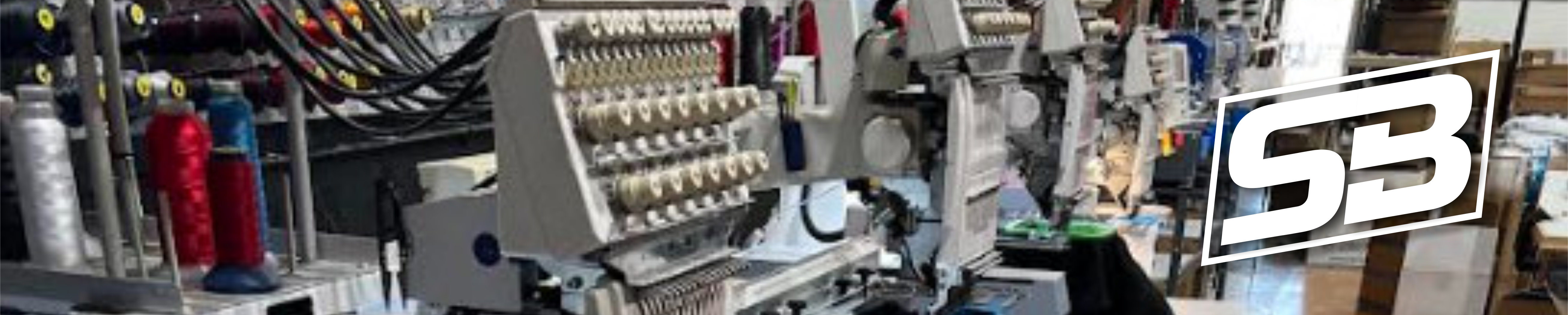 Embroidery machine stitching a Stewart Branding design